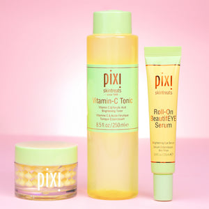 Pixi skincare products including Vitamin-C CreamSerum, Vitamin-C Tonic and Roll-on BeautifEYE Serum for eyes on a pink background