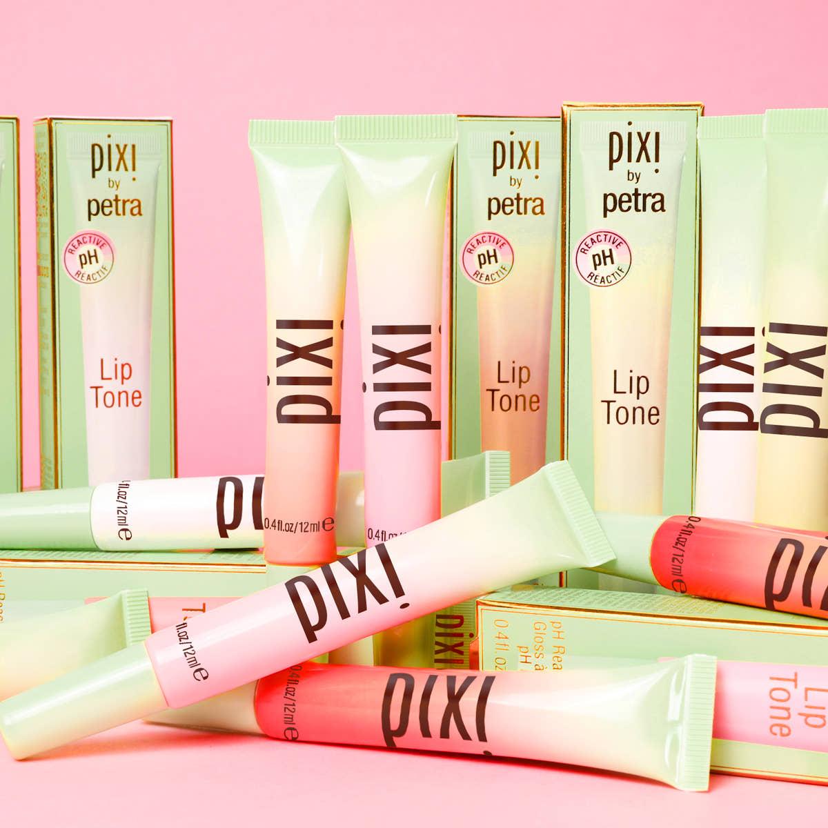 LipTone all shades shown on a pink background alongside box packaging